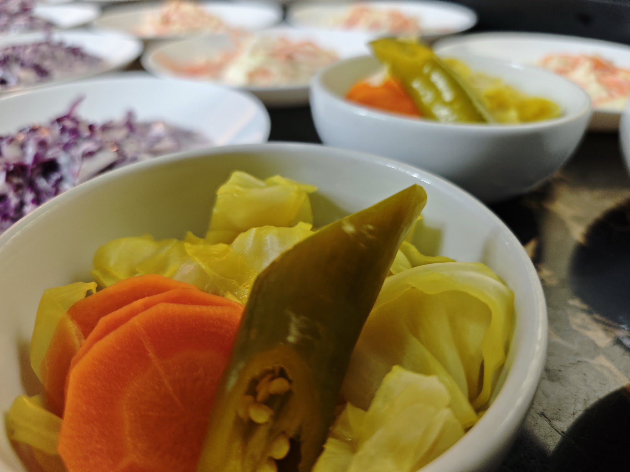 Pickles served with an assortment of salads and appetizers